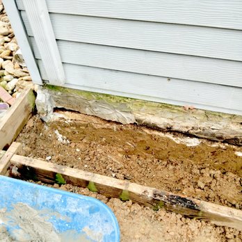 L & M Contractors - a man pouring concrete into a wheelbarrow - Landscaping Near Me L & M Contractors - a man pouring concrete into a wheelbarrow - Landscaping Near Me