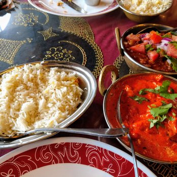 Taj Indian Cuisine - Butter Chicken in forefront. - Indian Near Me - Tampa, Florida Taj Indian Cuisine - Butter Chicken in forefront. - Indian Near Me - Tampa, Florida