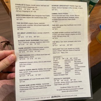 ORIGIN - a person holding a menu in their hand - Chicken Wings Near Me - Sarasota, Florida