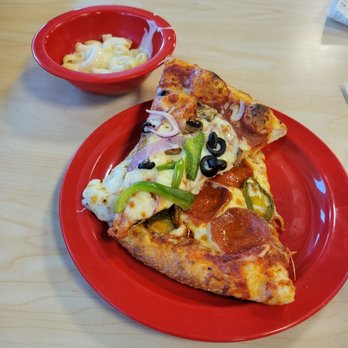 Cicis Pizza - a slice of pizza on a red plate - Pizza Near Me - El Paso, Texas