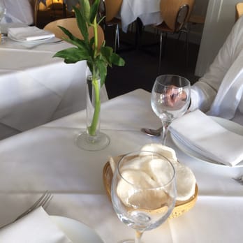 Sri Suwoon - Single stem red rose and a small starter (shrimp chips?) at every table. - Thai Near Me - London, XGL