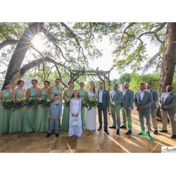 Living Sculpture Sanctuary - Wedding party posed before rustic arch @ Living Sculpture Sanctuary - Venues & Event Spaces Near Me - Davie, Florida