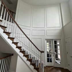 JA Painting - Custom wall molding installation and painting to create a modern staircase feature wall. Clean, elegant, and built to last.