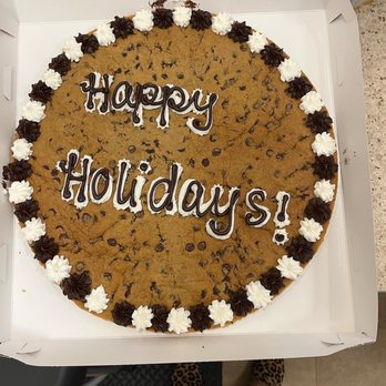 Great American Cookies - a chocolate chip cookie with happy holidays written on it - Bakeries Near Me - Houston, Texas