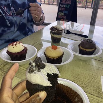 Smallcakes A Cupcakery - a person taking a bite - Cupcakes Near Me - Stillwater, Oklahoma Smallcakes A Cupcakery - a person taking a bite - Cupcakes Near Me - Stillwater, Oklahoma