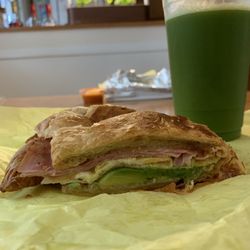 Donuts & Sandwich Station - Egg, cheese, and ham croissant with added avocado and a large green juice