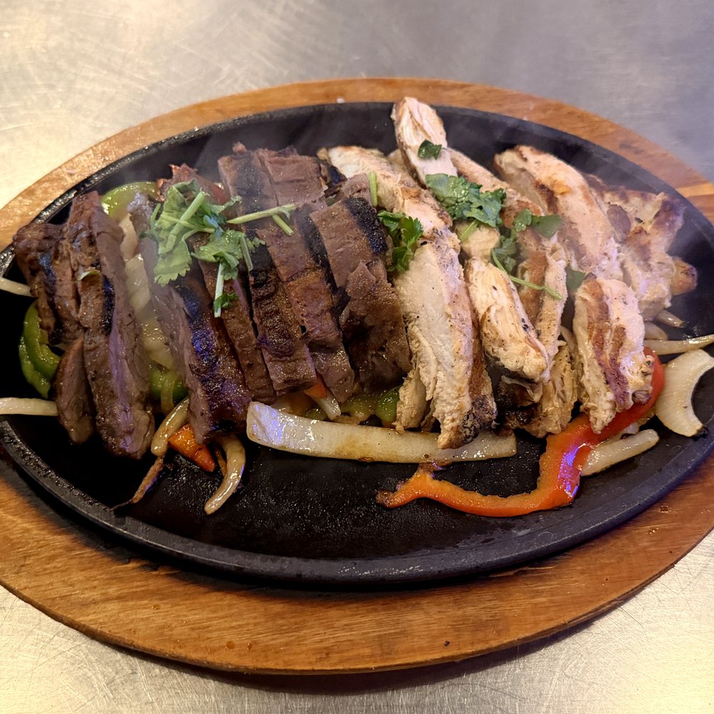 Uncle Bear's Grill and Tap - Mesa - Steak and Chicken Fajita Meat on Fajita Veggies - Toppings and Tortillas Included but Not Shown - Sports Bars Near Me - Mesa, Arizona Uncle Bear's Grill and Tap - Mesa - Steak and Chicken Fajita Meat on Fajita Veggies - Toppings and Tortillas Included but Not Shown - Sports Bars Near Me - Mesa, Arizona