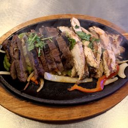 Uncle Bear's Grill and Tap - Mesa - Steak and Chicken Fajita Meat on Fajita Veggies - Toppings and Tortillas Included but Not Shown