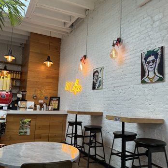 787 Coffee - tables and stools in a coffee shop - Coffee Roasteries Near Me - Bronx, New York