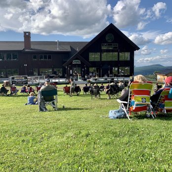 Saddleback Mountain - Sunny lawn with breathtaking views at Saddleback's Summer Mountain Music Series. - Hotels Near Me - Rangeley, Maine