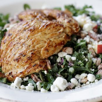 The Row - a white plate with a chicken and salad - Southern Near Me - Nashville, Tennessee