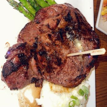 Redstone American Grill - Ribeye Steak, grilled asparagus and garlic mashed potatoes - Steakhouses Near Me - Oakbrook Terrace, Illinois Redstone American Grill - Ribeye Steak, grilled asparagus and garlic mashed potatoes - Steakhouses Near Me - Oakbrook Terrace, Illinois