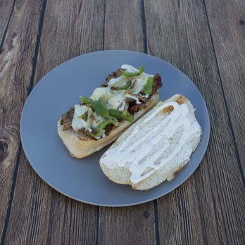Mustafa's Halal Gyro - a half eaten sandwich on a plate - Food Trucks Near Me - Columbus, Ohio Mustafa's Halal Gyro - a half eaten sandwich on a plate - Food Trucks Near Me - Columbus, Ohio