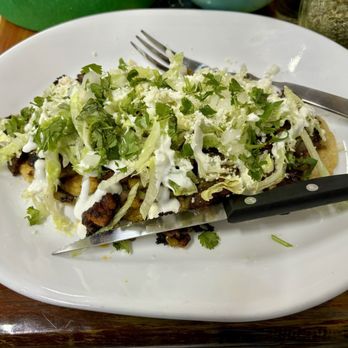 Lindo Michoacan - Not sure what this is called but it was a thick crispy corn tortilla bottom with grilled cactus, onion beans and lettuce. - Mexican Near Me - Anderson, Indiana