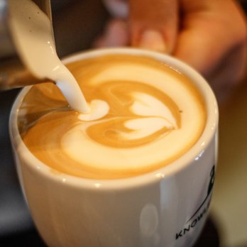 Knowledge Perk Coffee Company - a person pouring milk into a cup - Coffee & Tea Near Me - Columbia, South Carolina Knowledge Perk Coffee Company - a person pouring milk into a cup - Coffee & Tea Near Me - Columbia, South Carolina