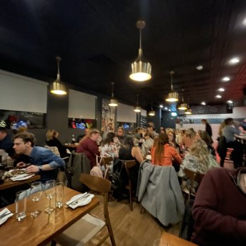 Le Marlow - a large group of people sitting at tables in a restaurant - French Near Me - Saint-Hubert, Quebec Le Marlow - a large group of people sitting at tables in a restaurant - French Near Me - Saint-Hubert, Quebec