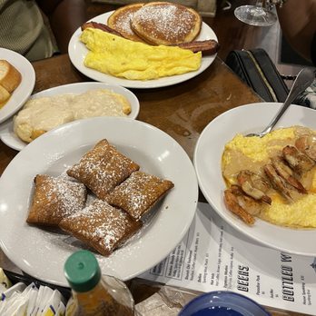 Fleur De Lis - Beignets along with omelet. Banana pancakes - Breakfast & Brunch Near Me - New Orleans, Louisiana