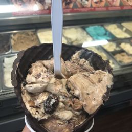 a hand holding a cup of ice cream a hand holding a cup of ice cream
