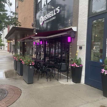 Bushell’s Kitchen & Cocktails - Exterior with pretty flowers. - Cocktail Bars Near Me - Traverse City, Michigan Bushell’s Kitchen & Cocktails - Exterior with pretty flowers. - Cocktail Bars Near Me - Traverse City, Michigan
