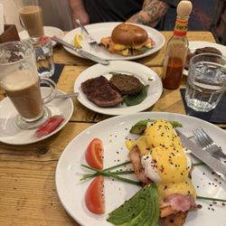 The Painted Rooster - Eggs Benedict with smoked salmon and bacon, breakfast bagel, and two side of haggis and sausage.