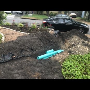 Innovative Water Solutions - During the project, pipes being installed to carry water to the street drain. - Landscaping Near Me - Austin, Texas