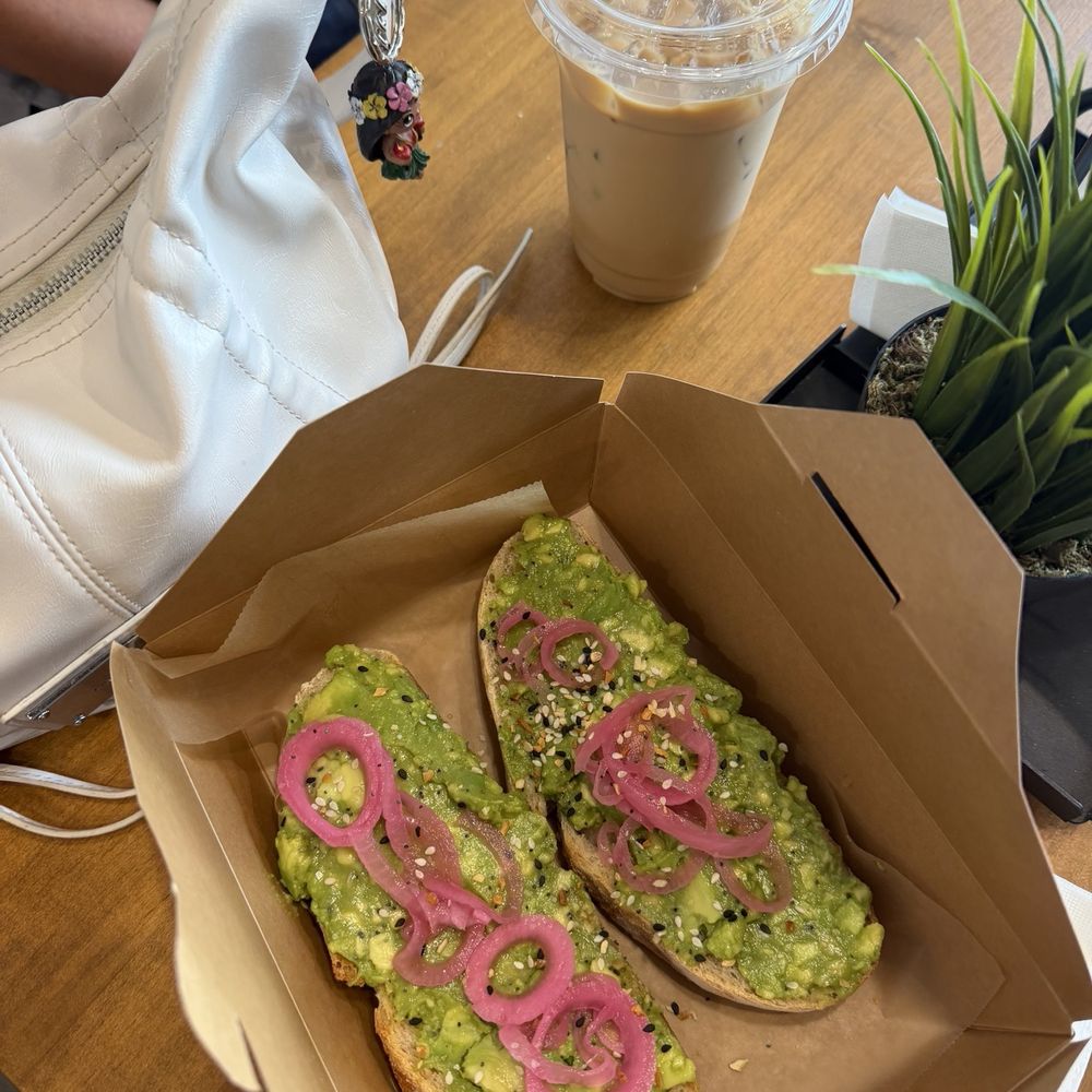 Avocado toast, and an iced sweet latte with vanilla Avocado toast, and an iced sweet latte with vanilla