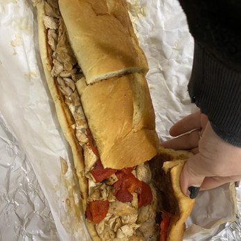 Big Wally's Subs - a person holding a sandwich - Sandwiches Near Me - Parlin, New Jersey