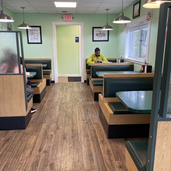 Murphy's Eats and Treats - a man sitting at a table - Burgers Near Me - Framingham, Massachusetts Murphy's Eats and Treats - a man sitting at a table - Burgers Near Me - Framingham, Massachusetts