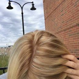 Highlights and touch up on naturally dark blond hair came out very brassy and orangish. Done by Lauren