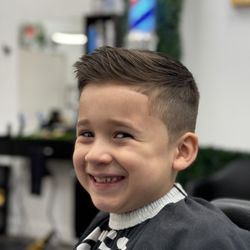 His & Hers Lux Barbershop - A happy kid with a cool haircut in Boca Raton