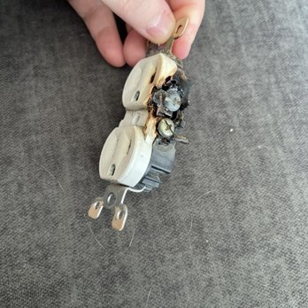 Frayer Electric - Burnt electrical outlet from my living room - Electricians Near Me