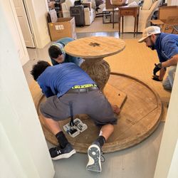Navarro-Melia Movers - Carefully assembling a dining table.