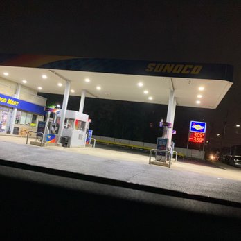 Sunoco - Nighttime view of a Sunoco gas station with fuel pumps, a convenience store labeled 'Food Mart,' and illuminated signage displaying fuel prices. - Gas Stations Near Me - Cliffside Park, New Jersey