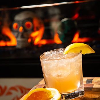 Barrio Queen - a glass of orange juice with a slice of lemon - Mexican Near Me - Queen Creek, Arizona