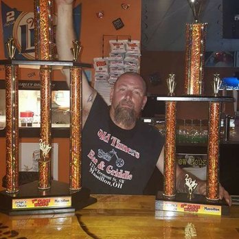 Old Timers Bar and Griddle - a man holding a trophy - Bars Near Me - Massillon, Ohio