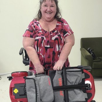 Triple M Mobility - A happy customer holding the words lightest scooter!! - Mobility Equipment Sales & Services Near Me - Houston, Texas Triple M Mobility - A happy customer holding the words lightest scooter!! - Mobility Equipment Sales & Services Near Me - Houston, Texas