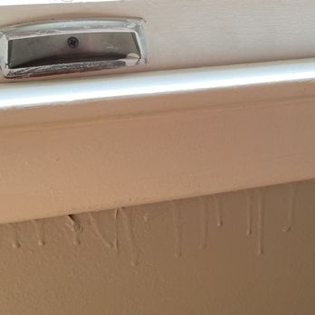 Bouley's Painting - Paint dripping under a window. Note the window hardware - only one screw but too much trouble to remove. - Painters Near Me