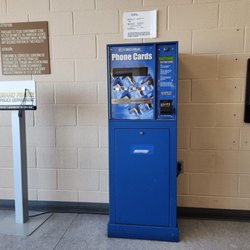 Grand Prairie Police Department - Chargers, phone cards, and payphone in the waiting area
