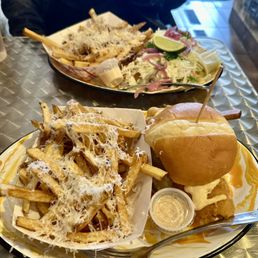 Spicy Fish Sandwich with truffle fries upgrade. Fish tacos with garlic Asiago fries upgrade in the back