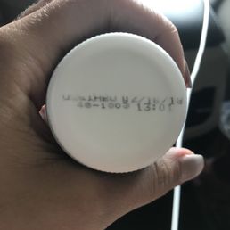 a hand holding a white button a hand holding a white button