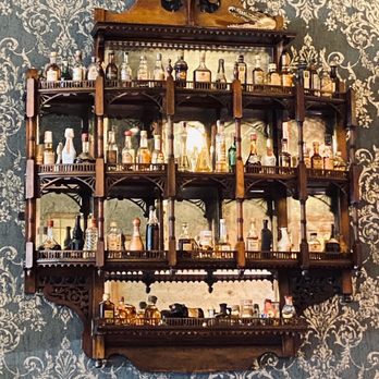 Rocco's - Antique Knick-knack shelf displaying mini bottles - Bars Near Me - Seattle, Washington Rocco's - Antique Knick-knack shelf displaying mini bottles - Bars Near Me - Seattle, Washington
