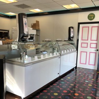 DAT’s - Ice cream and Italian ice. - A glass display case with ice cream and Italian ice is situated inside a retro-style eatery, featuring LP record-themed flooring and a pink and white door. - New American Near Me - Nazareth, Pennsylvania