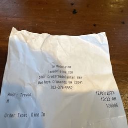 a receipt on a wooden table