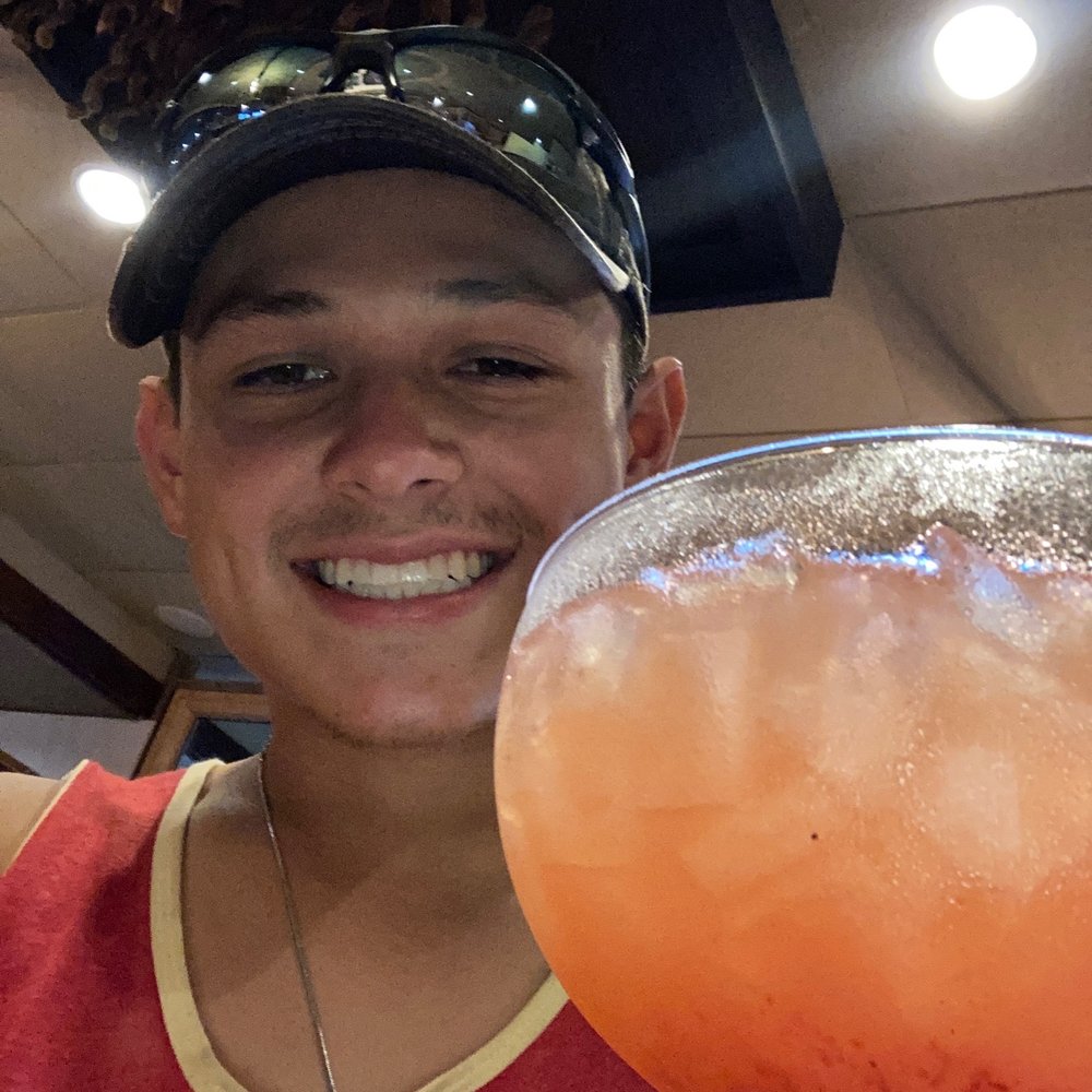 a man holding a margarita a man holding a margarita