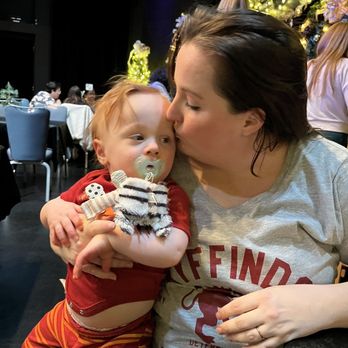 The Dessertery - a woman kissing a baby - Desserts Near Me - Raleigh, North Carolina