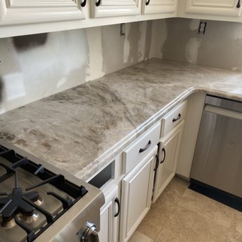 Marcor Finish Carpentry - a kitchen counter with a stove and dishwasher - General Contractors Near Me