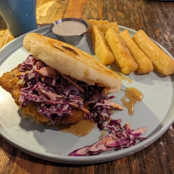 Hola Arepa - Hot Honey Chicken Arepa with Yucca Fries - just look at the dreamy coleslaw and hot honey spilling out and try not to drool - Latin American Near Me - Minneapolis, Minnesota