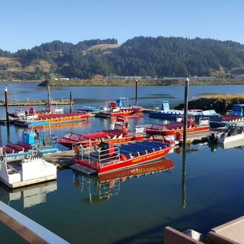 Jerry's Rogue Jets - All of the jet boats docked except one that already left. We rode the blue one to the left named "The Wildcat". - Boating Near Me - Gold Beach, Oregon