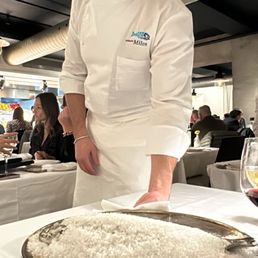 Our waiter serving the salt crusted fish