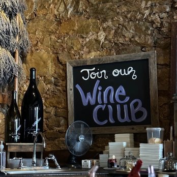 Lavender Ridge Vineyard - a wine club sign and bottles of wine - Wine Tasting Room Near Me - Murphys, California